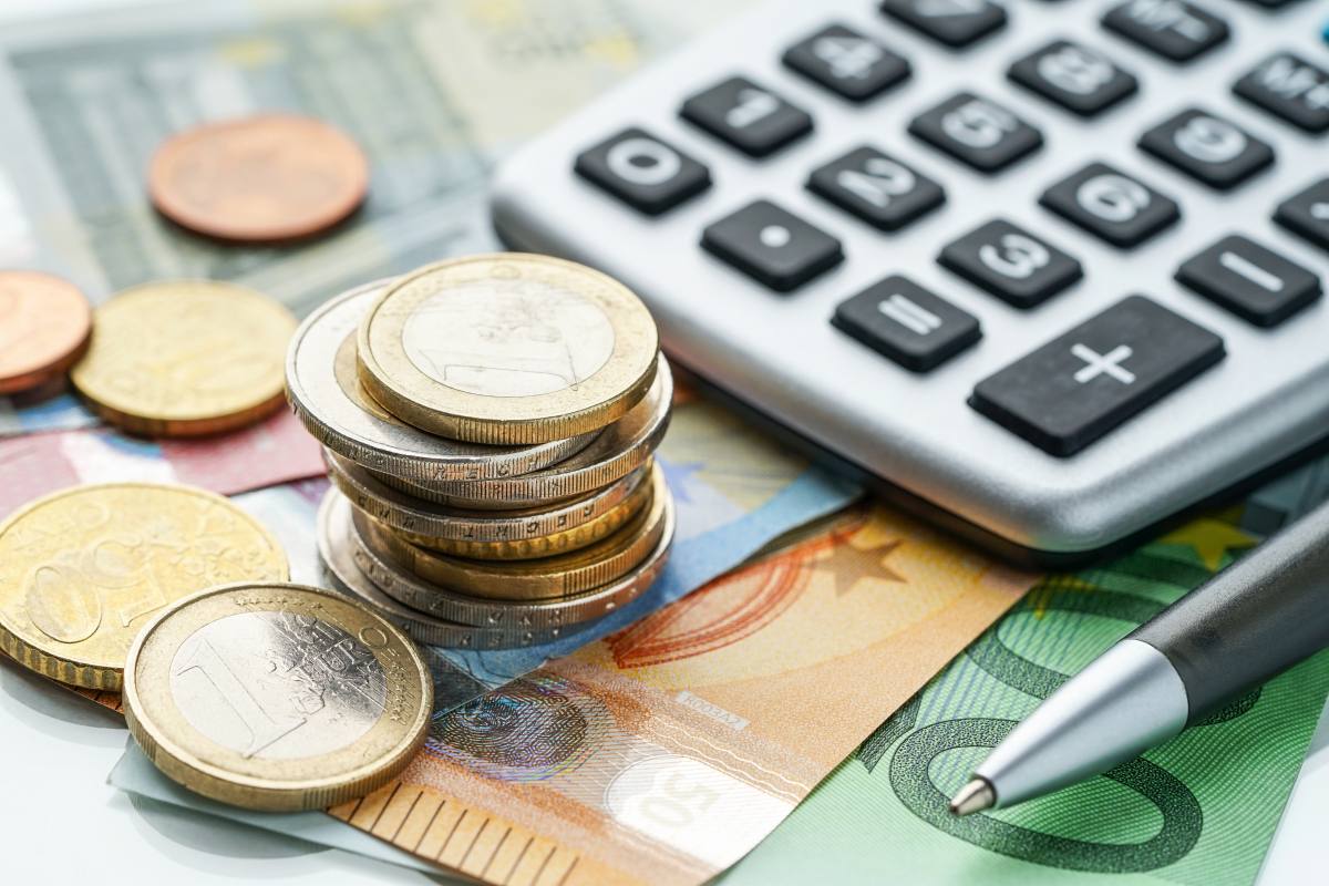 Euromünzen, Geldscheine und ein Taschenrechner